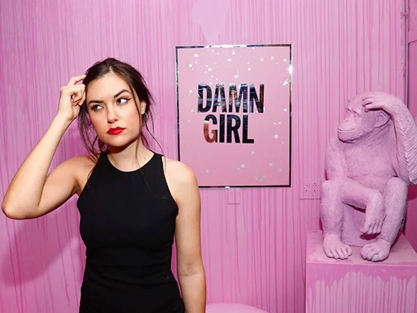 Portrait beside pink artwork and a monkey sculpture, from Jeremy Penn’s Saks portfolio